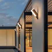 Contemporary outdoor wall lantern light fixtures illuminating a stylish outdoor living area.