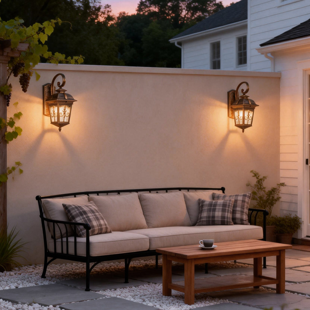 Contemporary outdoor wall lights mounted on a white exterior wall above a backyard sofa.
