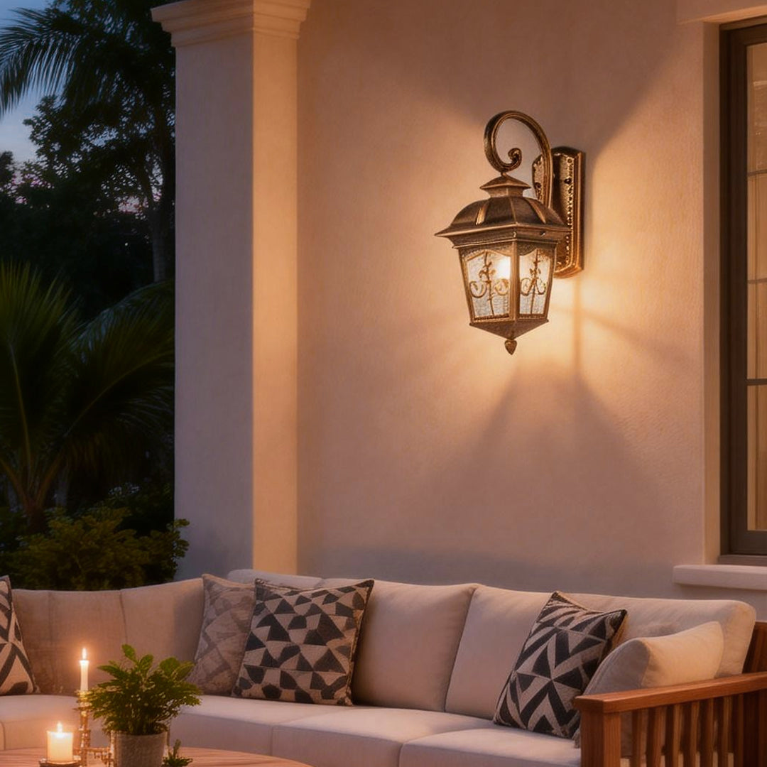 Contemporary outdoor wall light illuminating a covered patio seating area at dusk.