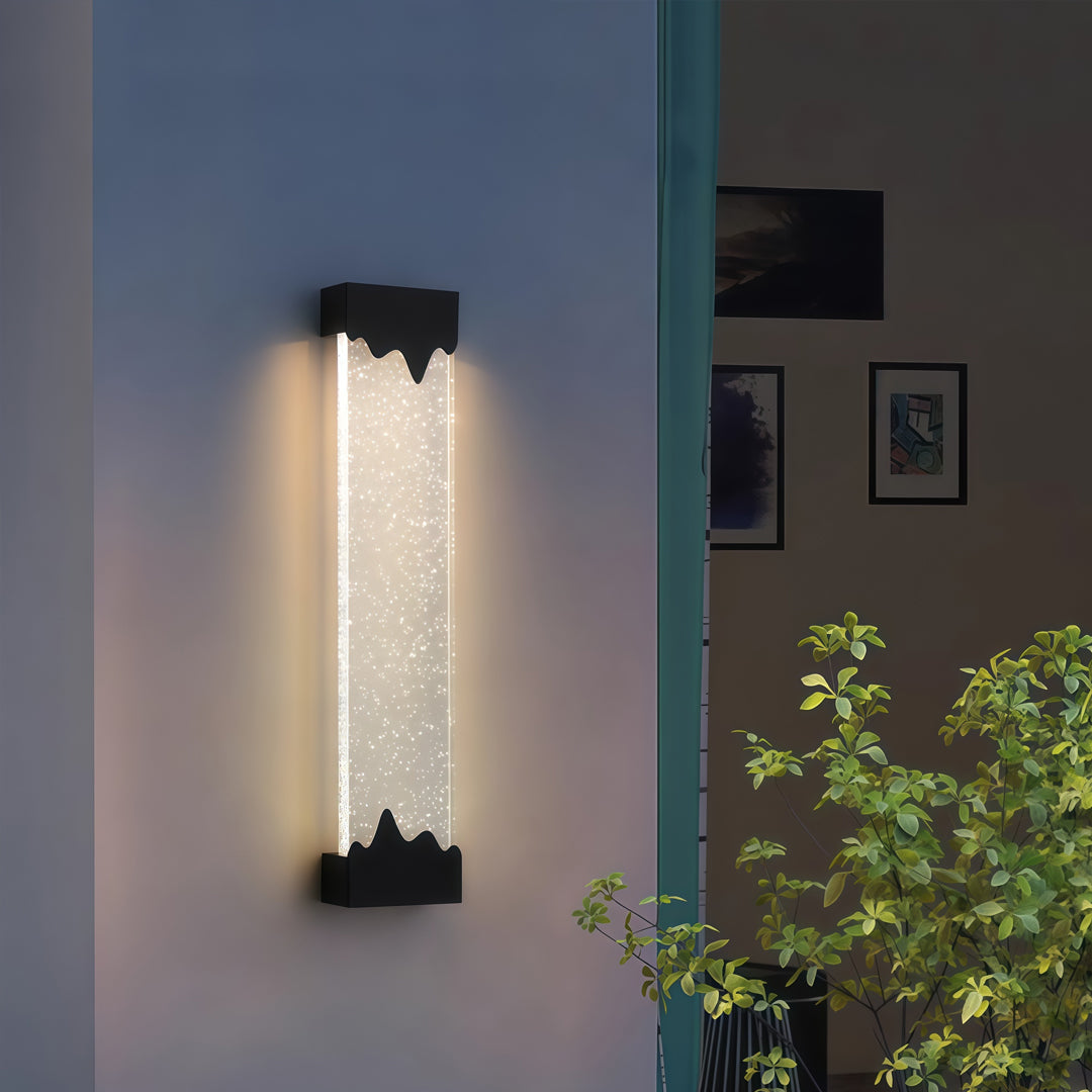 Contemporary outdoor wall lighting black linear fixture on blue wall with greenery creating ambient outdoor lighting