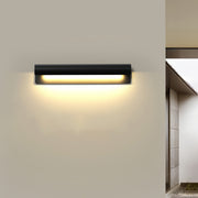 Contemporary outdoor wall lighting copper sconce creating ambient illumination on beige interior wall beside doorway