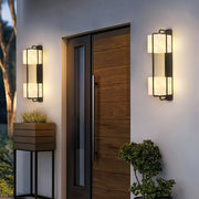 Contemporary outdoor wall lighting pair creating warm welcoming glow at modern home entryway