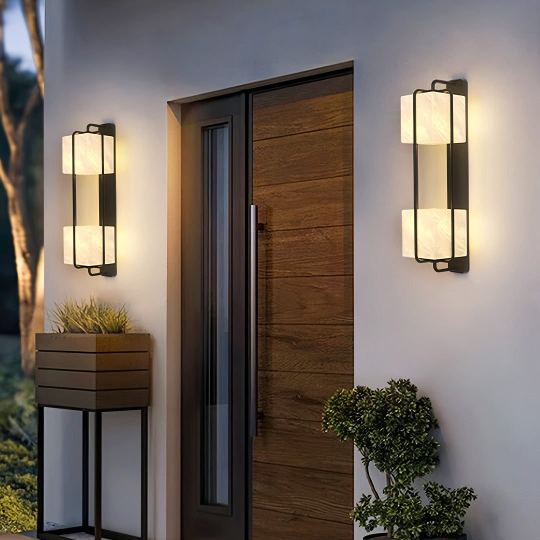 Contemporary outdoor wall lighting pair creating warm welcoming glow at modern home entryway