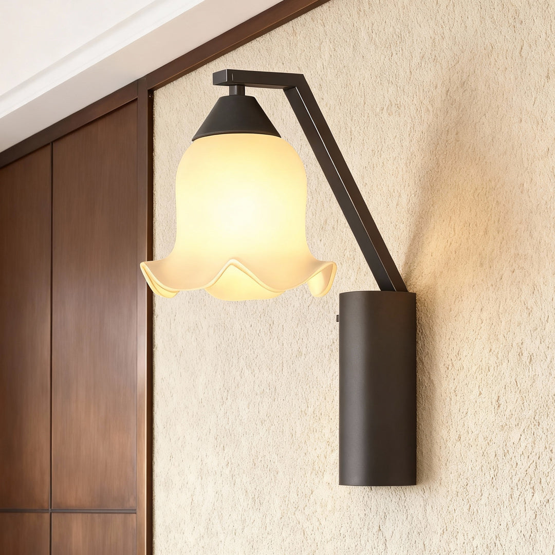 Contemporary outdoor wall lighting flower sconce on textured beige wall beside wooden door with warm ambient glow