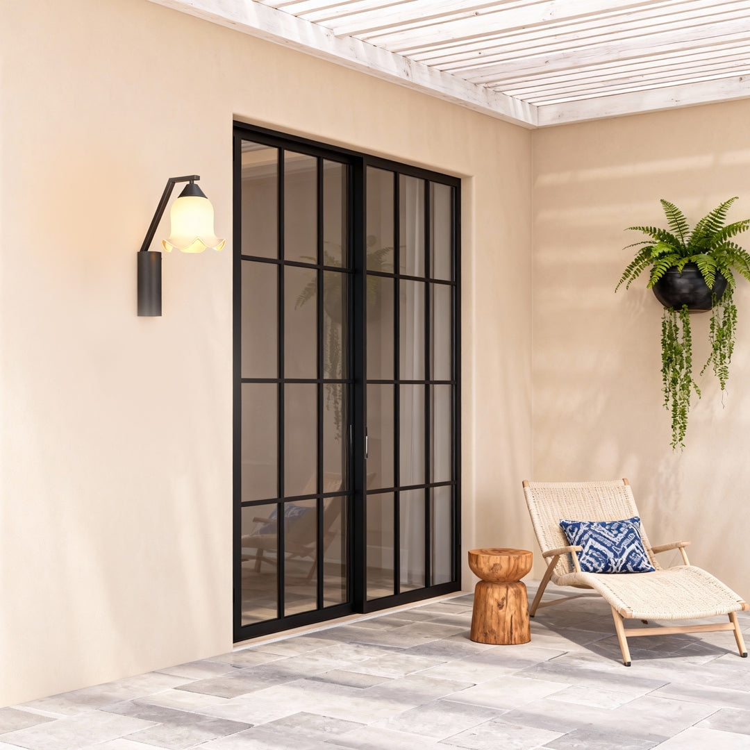 Contemporary outdoor wall lighting flower wall sconce illuminating modern patio entrance with black frame windows