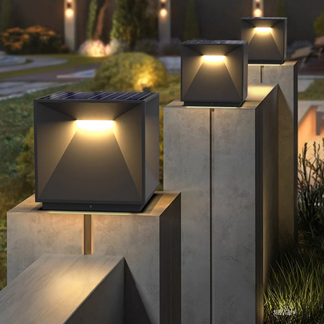 Contemporary outdoor wall lighting garden pillar light on concrete post beside modern home entrance at twilight