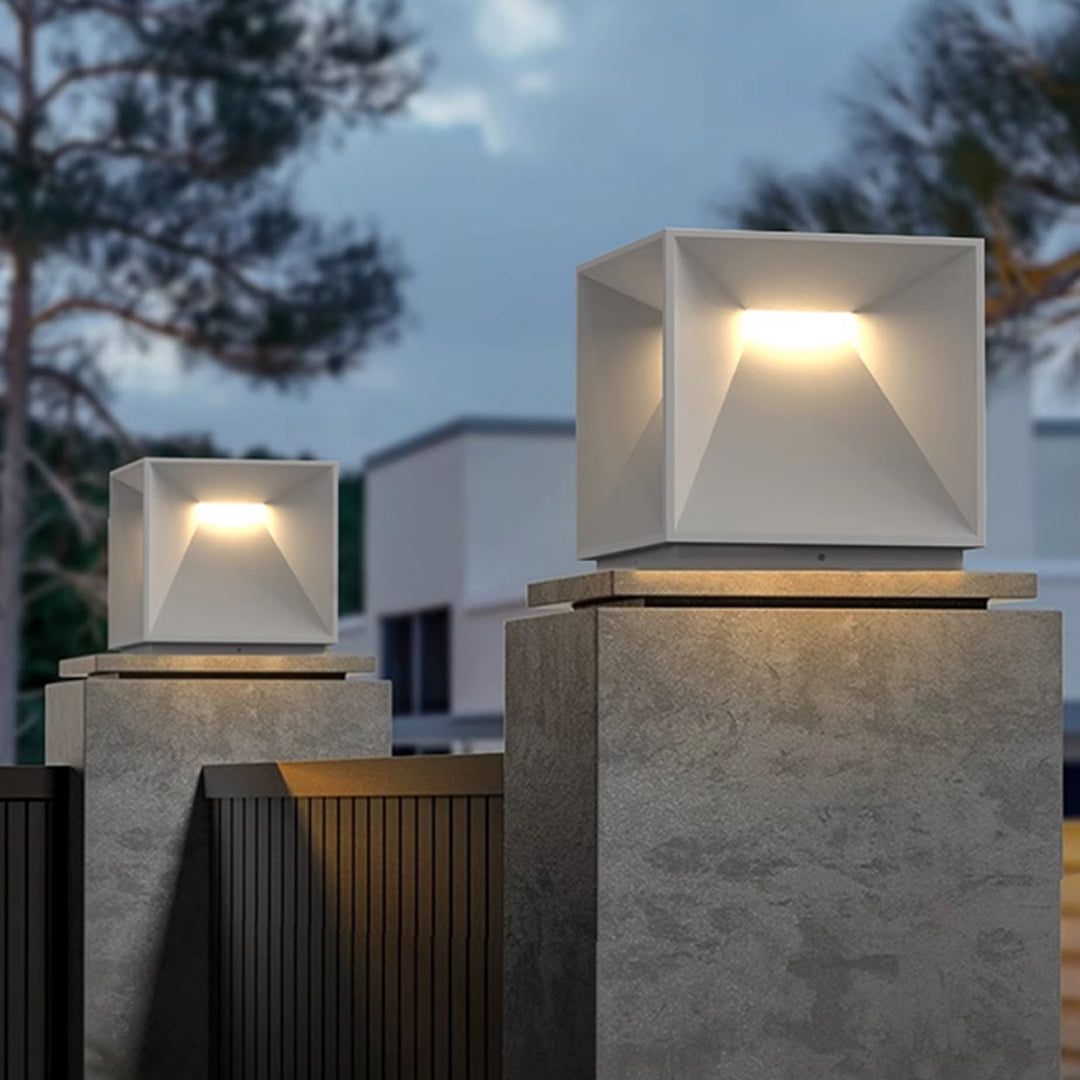 Contemporary outdoor wall lighting garden pillar lights illuminating modern landscaped yard with decorative pillars at dusk