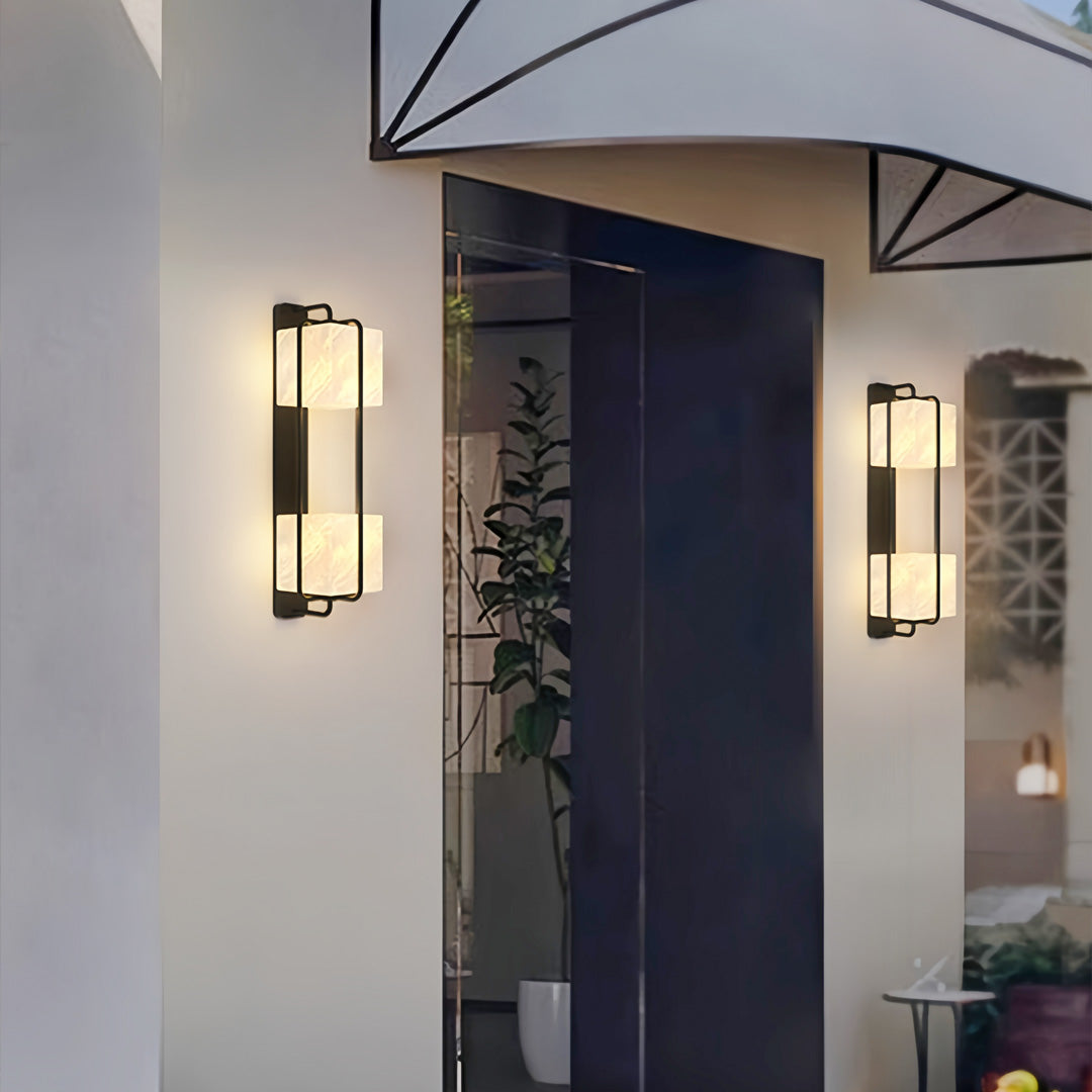 Contemporary outdoor wall lighting illuminating gray home exterior with dramatic evening ambiance