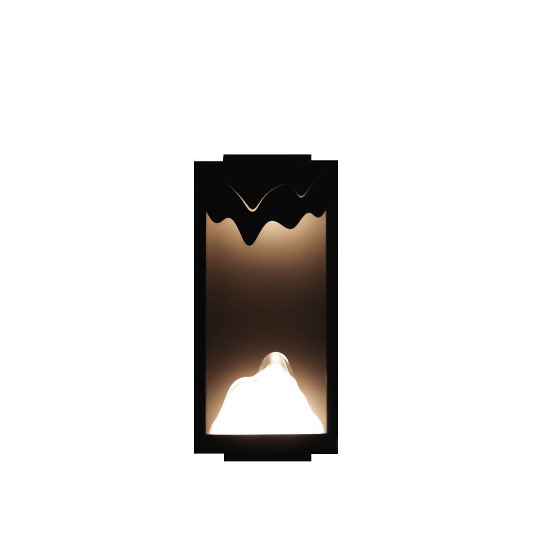 Contemporary outdoor wall lighting ideas featuring vertical fixture with mountain-peak cutout creating upward and downward light