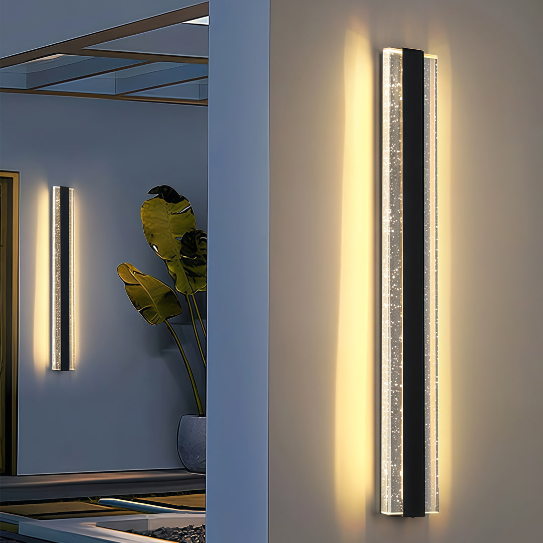 Contemporary outdoor wall lighting linear sconces flanking entrance with blue architectural panels and warm ambiance