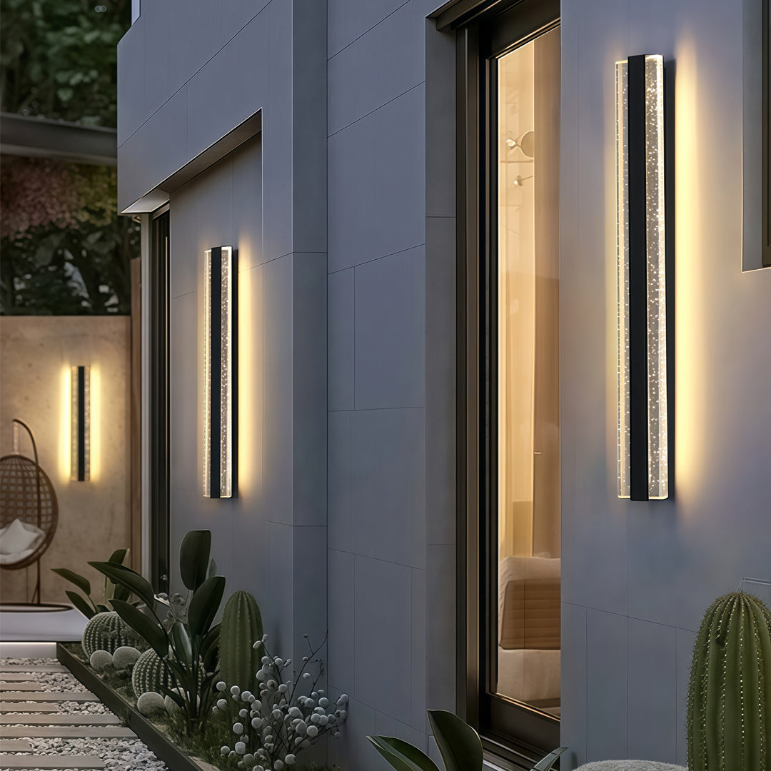 Contemporary outdoor wall lighting modern linear sconces illuminating blue gray exterior walls at evening