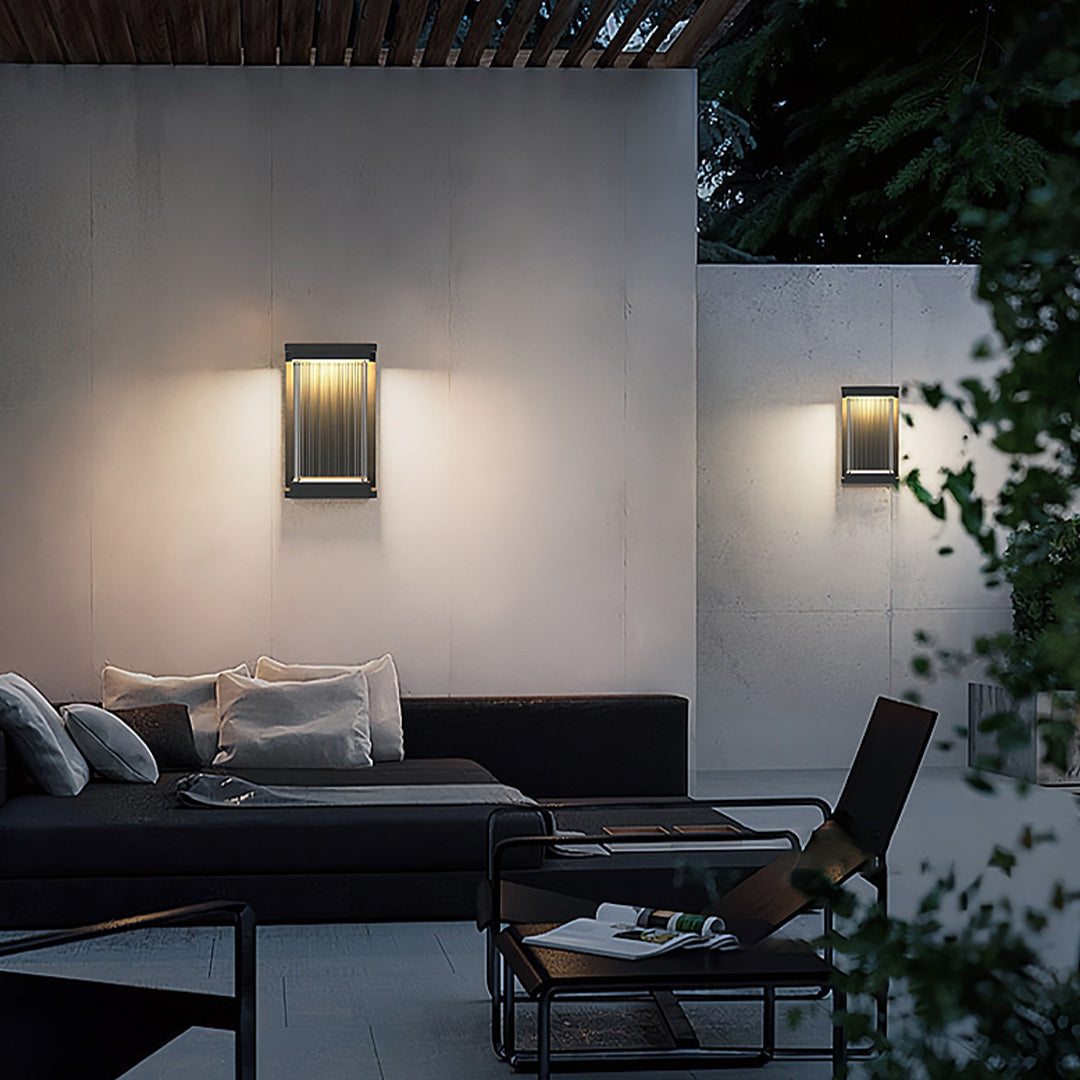 Contemporary outdoor wall lighting linear fixtures creating ambient glow on modern patio lounge area