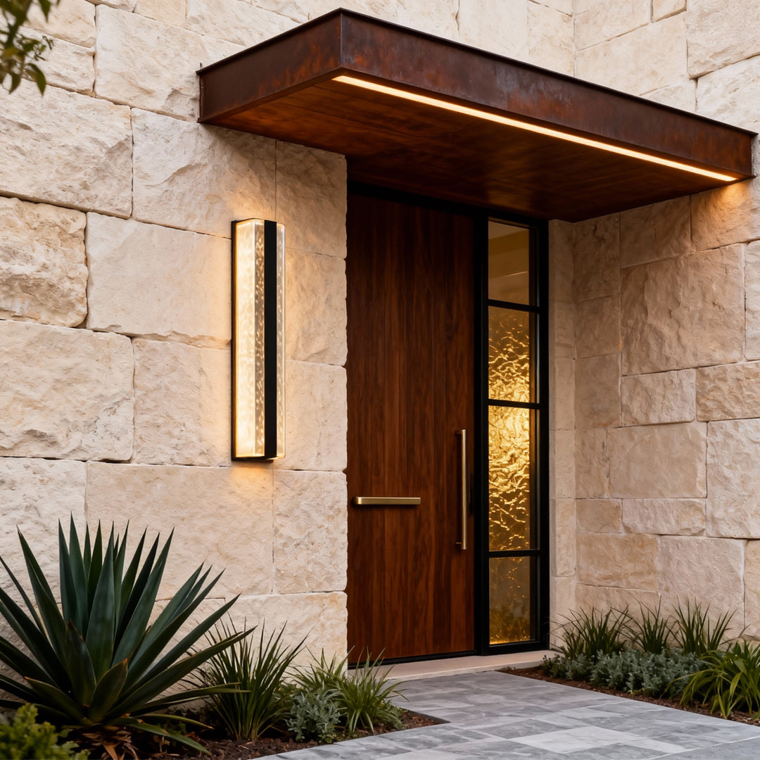 Contemporary outdoor wall lighting linear sconce mounted beside wooden door on stone exterior wall