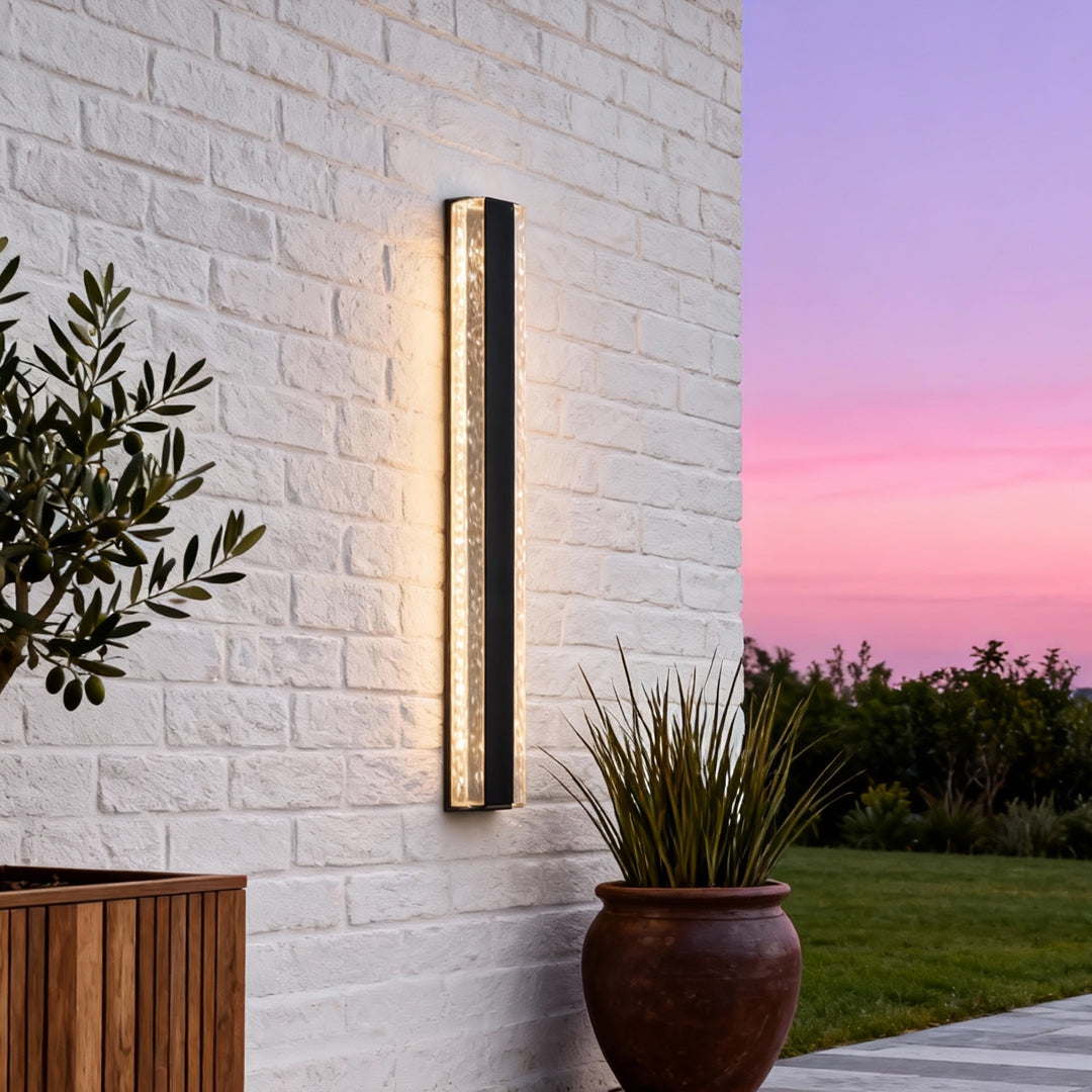 Contemporary outdoor wall lighting modern linear sconce on white brick wall at sunset with warm glow