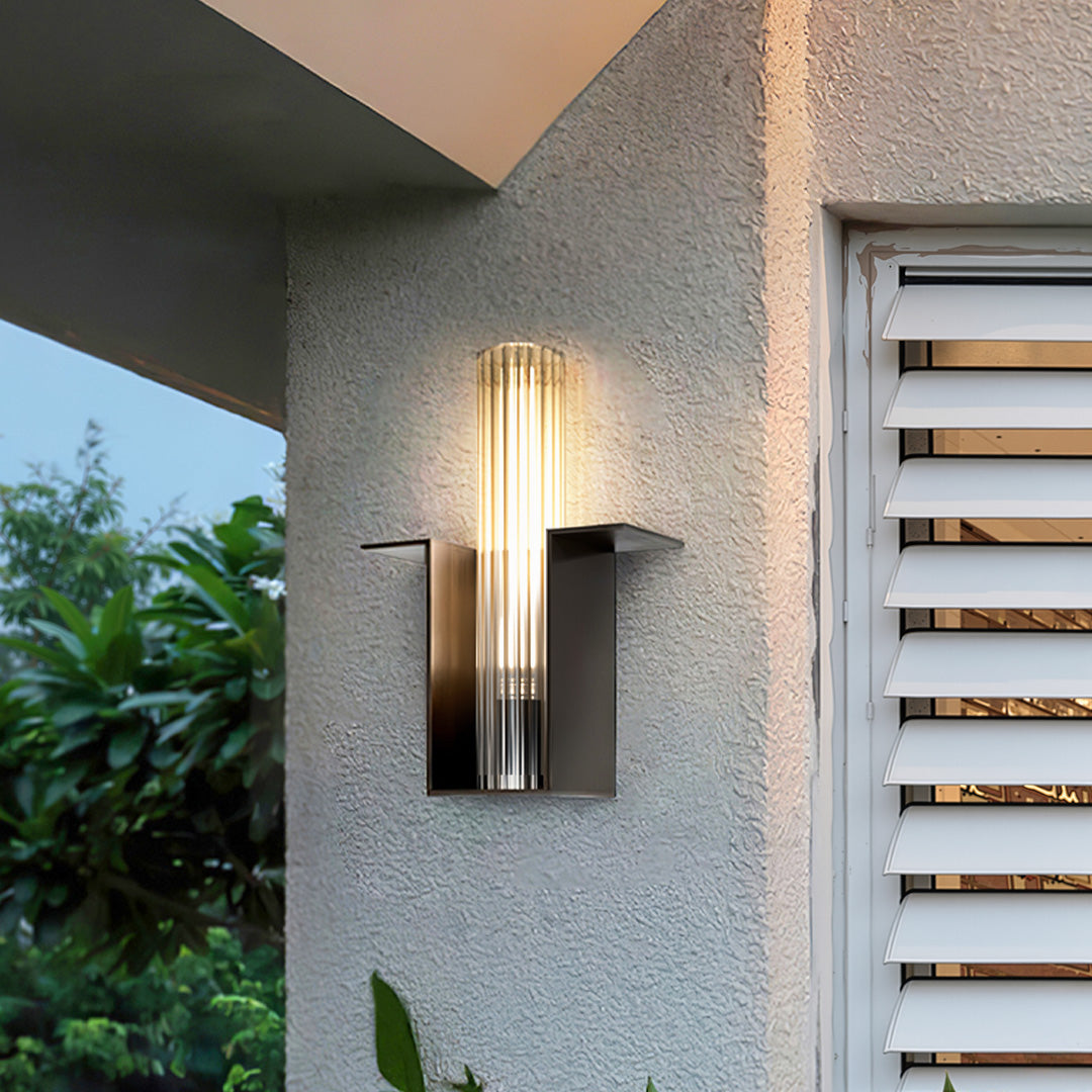 Contemporary outdoor wall lighting installed beside modern entrance with wooden door accents and landscaping