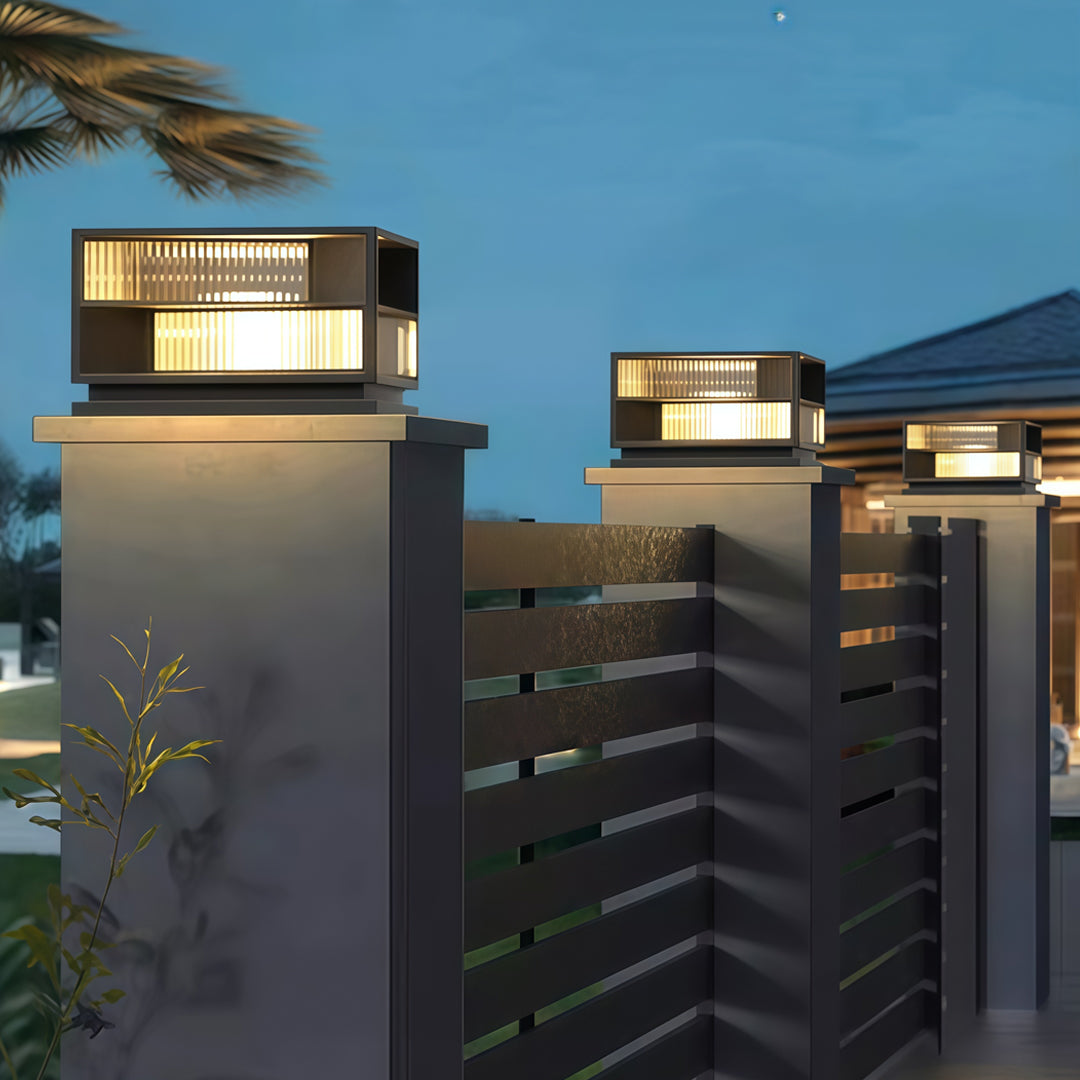 Contemporary outdoor wall lighting pillar LED fixture mounted on modern gray concrete architectural column at dusk