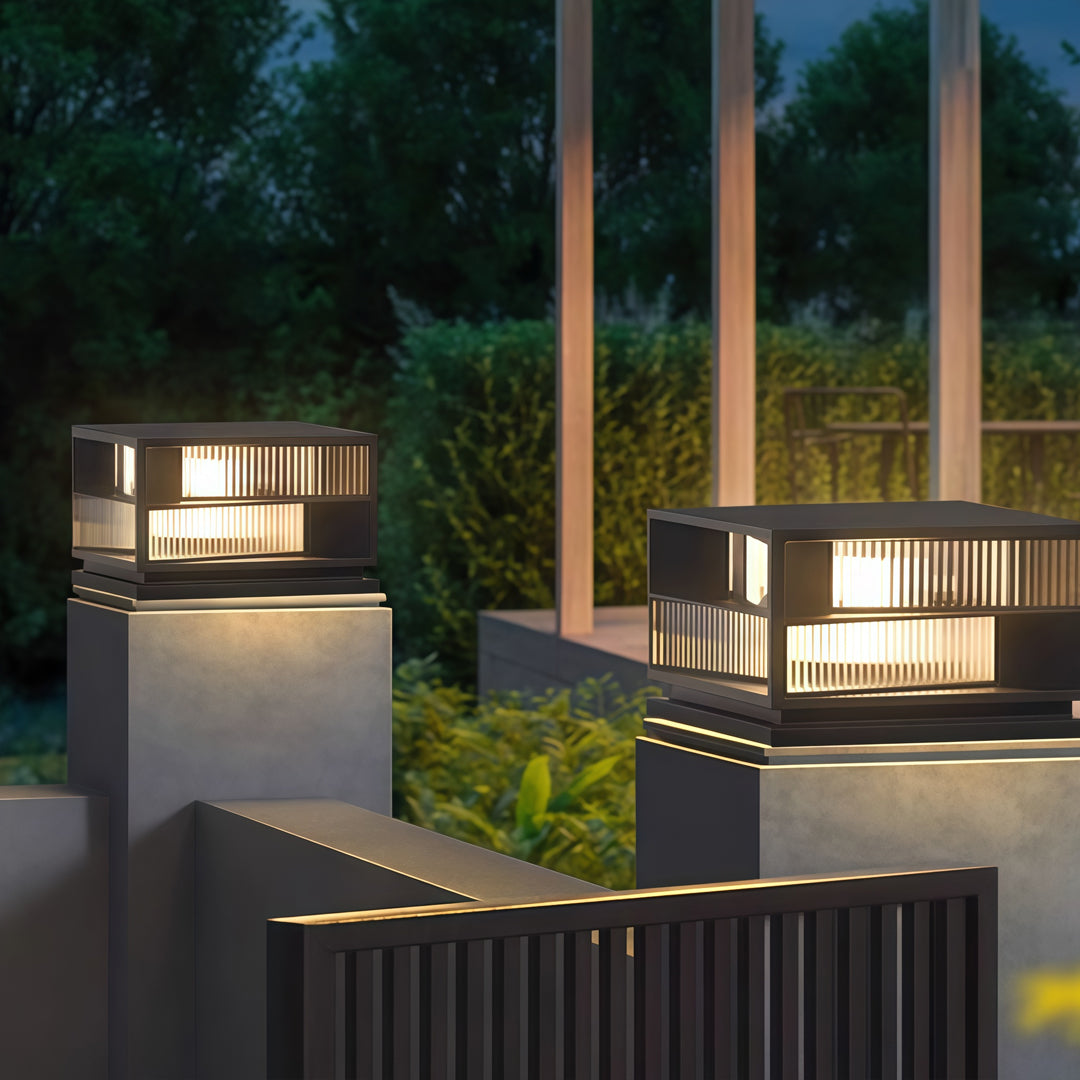 Contemporary outdoor wall lighting pillar LED lights on modern garden pillars with landscaping at twilight
