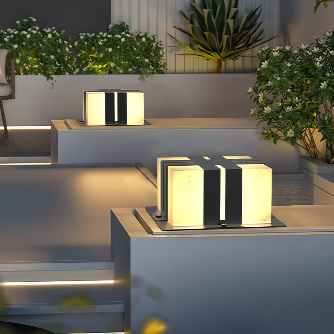 Contemporary outdoor wall lighting pillar LED light creating warm ambiance on minimalist white outdoor wall