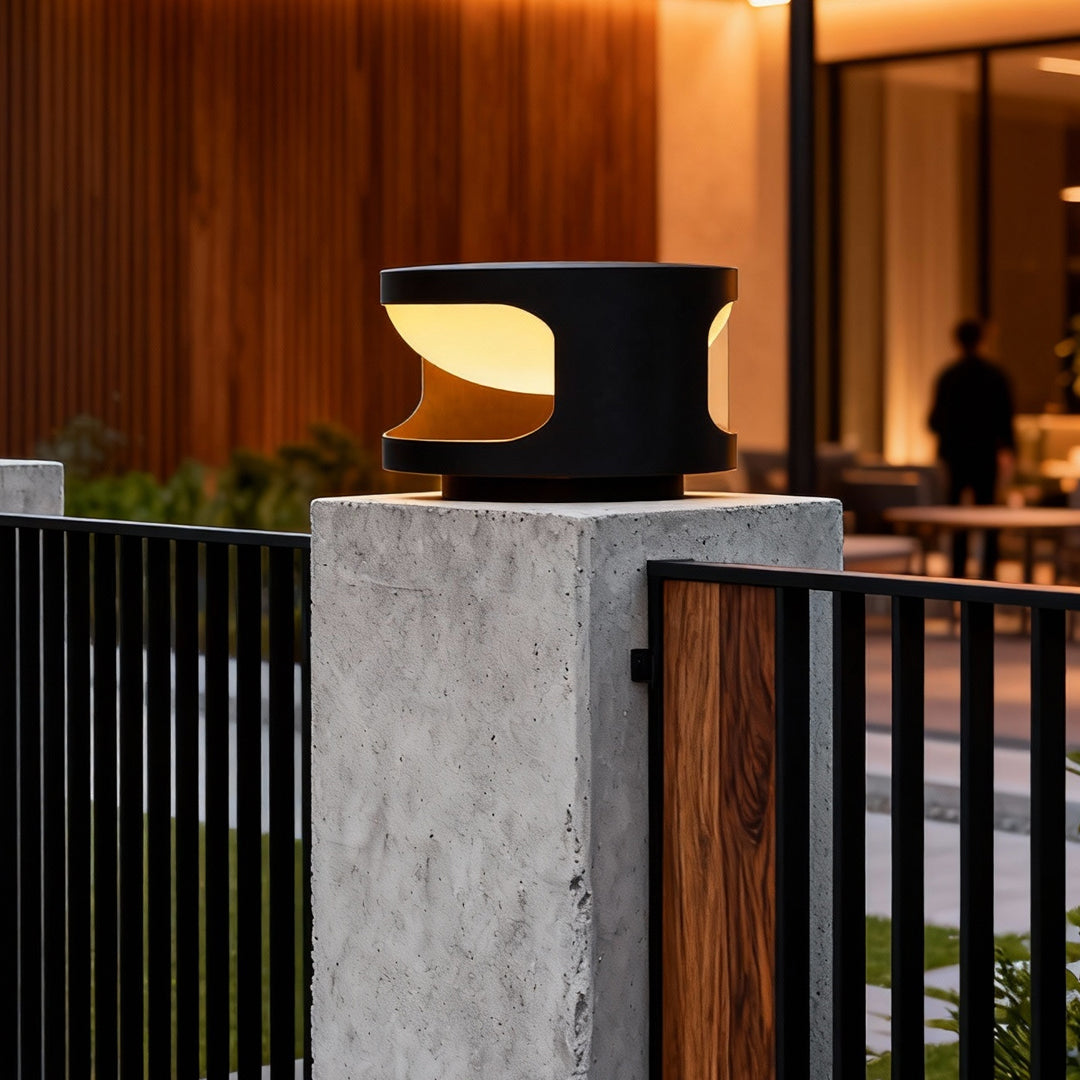 Contemporary outdoor wall lighting pillar top lights on concrete posts creating ambient evening glow at dusk