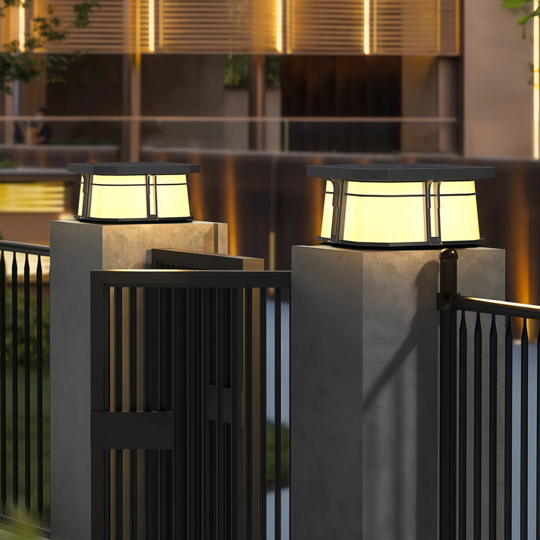 Contemporary outdoor wall lighting pillar top lights illuminating modern dark columns on residential deck at dusk