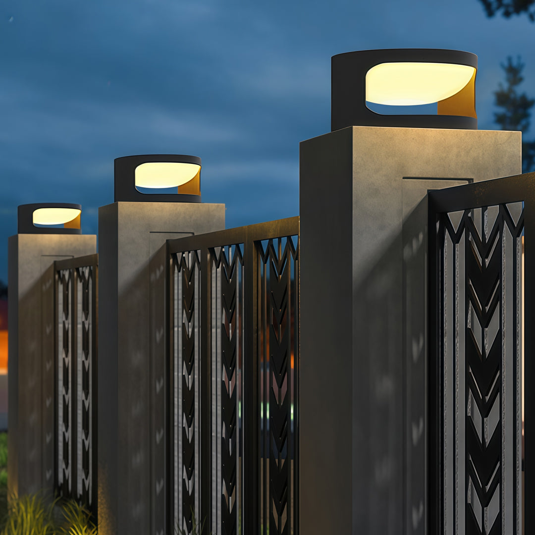 Contemporary outdoor wall lighting for pillar tops mounted on decorative pillars at modern residential entrance evening