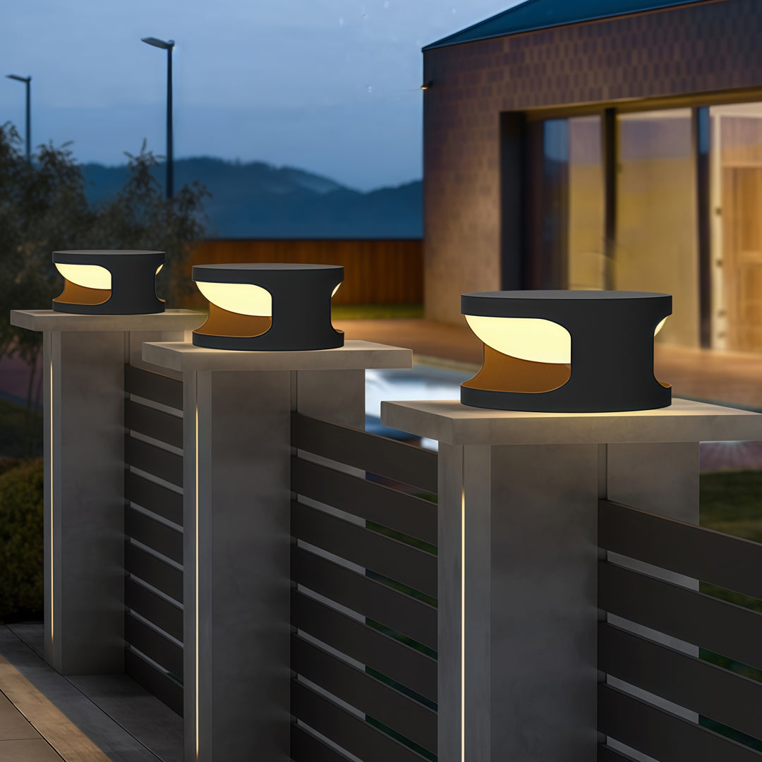 Contemporary outdoor wall lighting for pillar tops mounted on decorative pillars at modern residential entrance evening