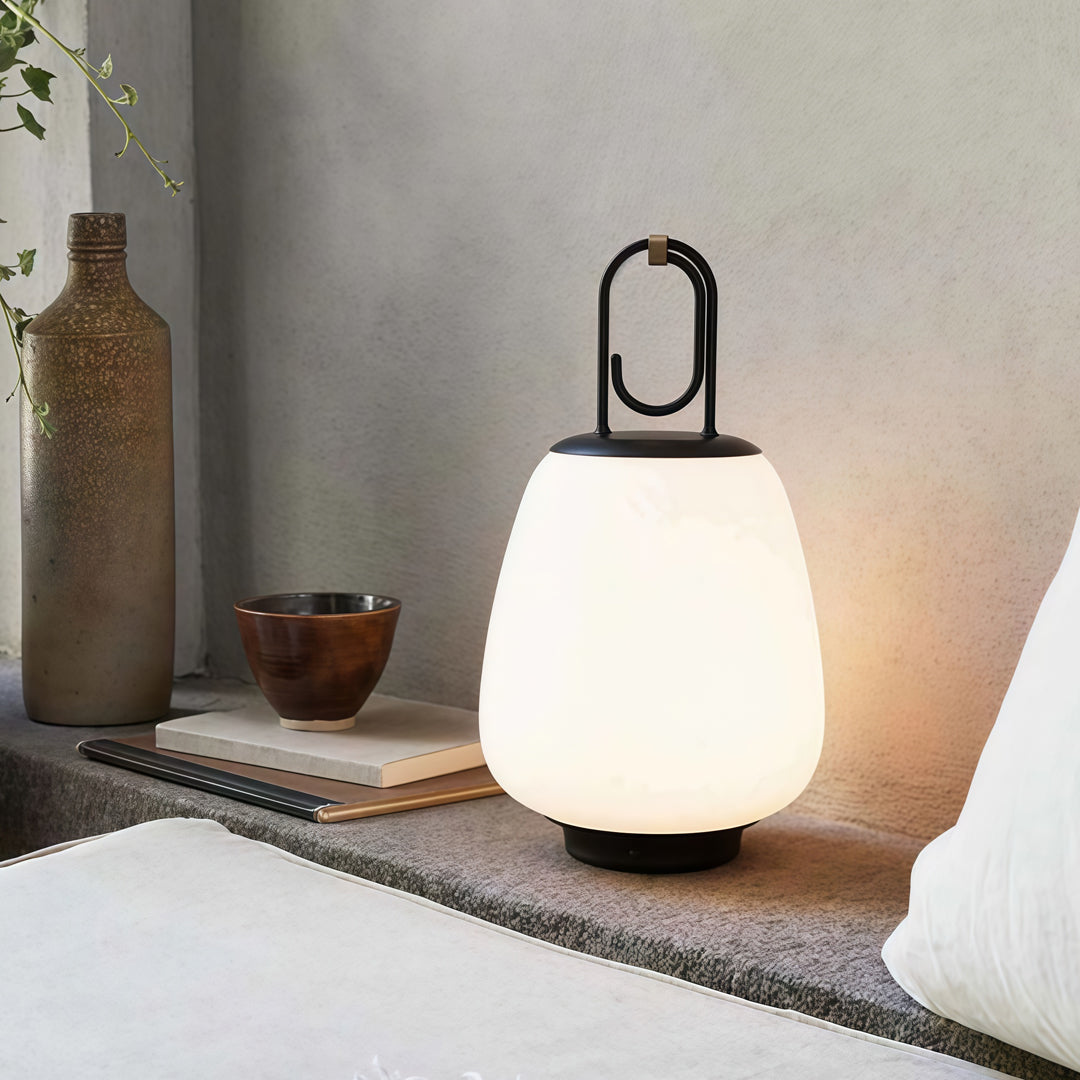 Contemporary outdoor wall lighting portable table lamp on white side table beside bed with soft illumination