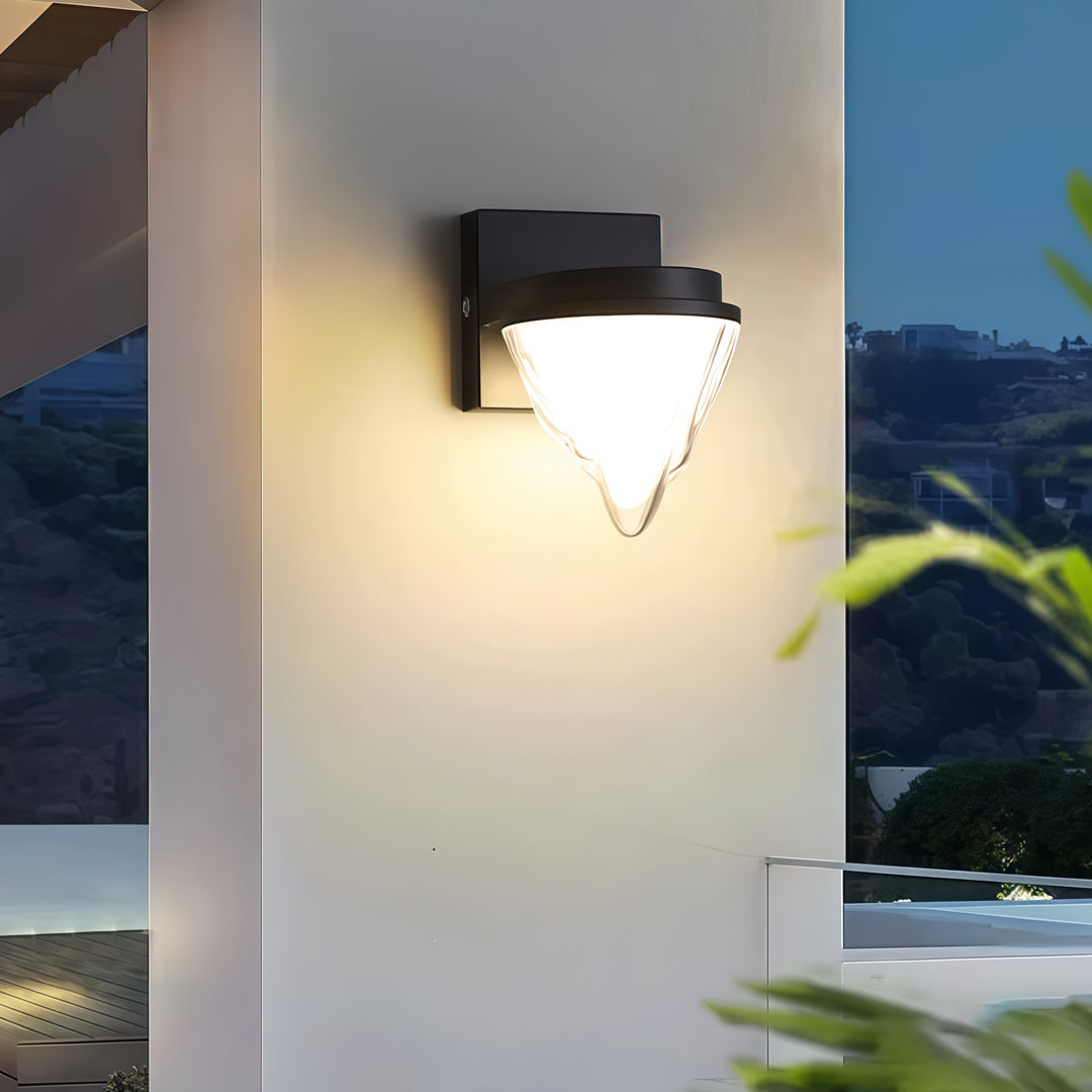 Contemporary outdoor wall lighting square wall sconce on white exterior wall beside blue door at evening