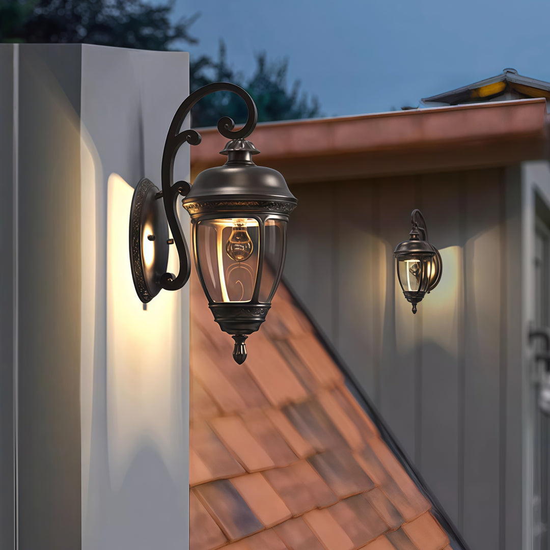 Contemporary outdoor wall lighting vintage sconce lamps flanking entrance on white stucco wall with terracotta roof
