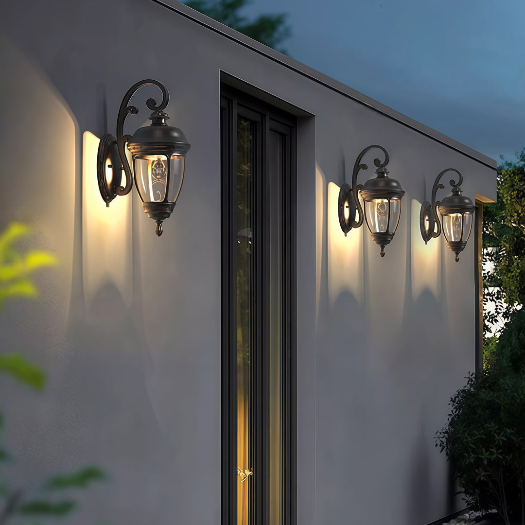 Contemporary outdoor wall lighting vintage sconce lamps illuminating gray corrugated metal facade at evening twilight