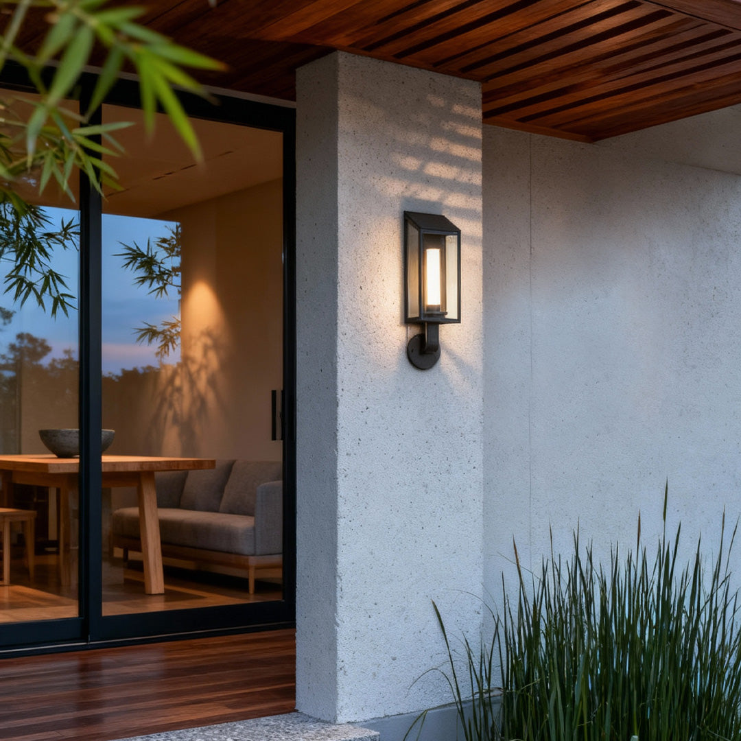 Contemporary outdoor wall mount light fixture mounted on a stone exterior wall, providing warm architectural lighting.