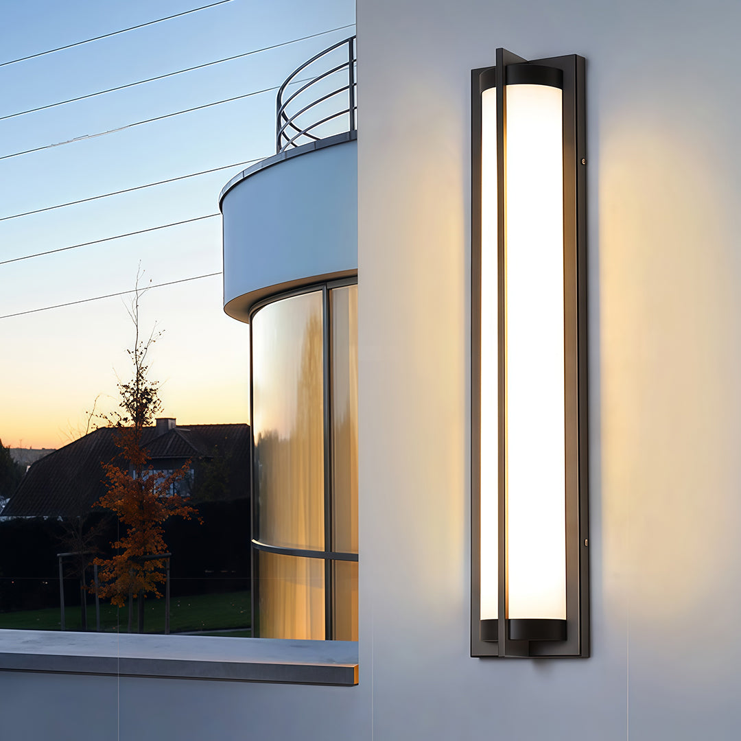 Contemporary outdoor wall sconces black with glass shade chandelier aesthetic creating dramatic accent lighting on modern blue and white exterior.
