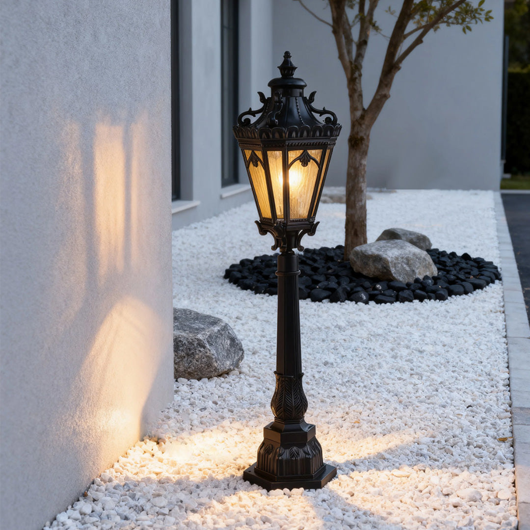 Contemporary pathway lighting bollard providing ambient glow on white stone surface at twilight