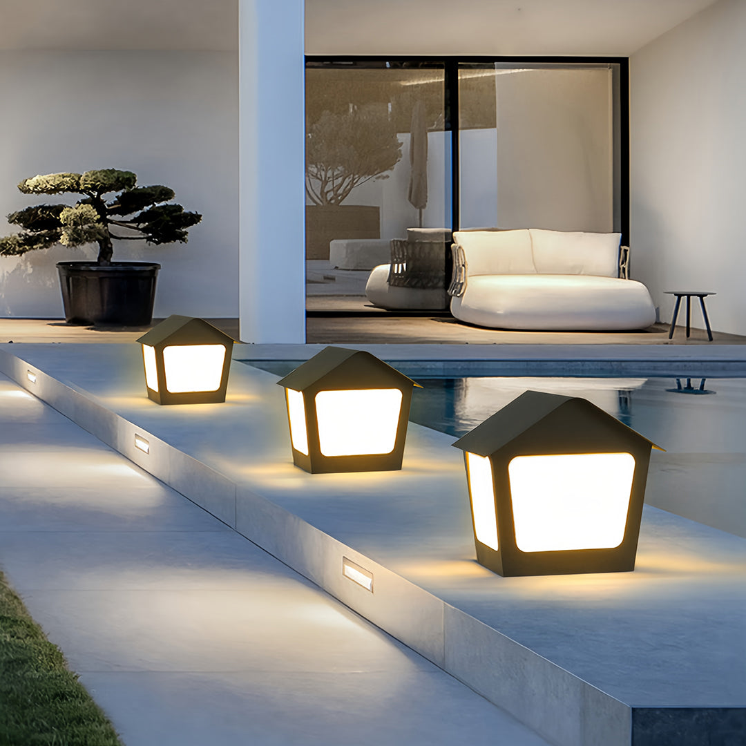 Contemporary deck post cap lights installed along steps and pathways leading to a modern home patio entrance.