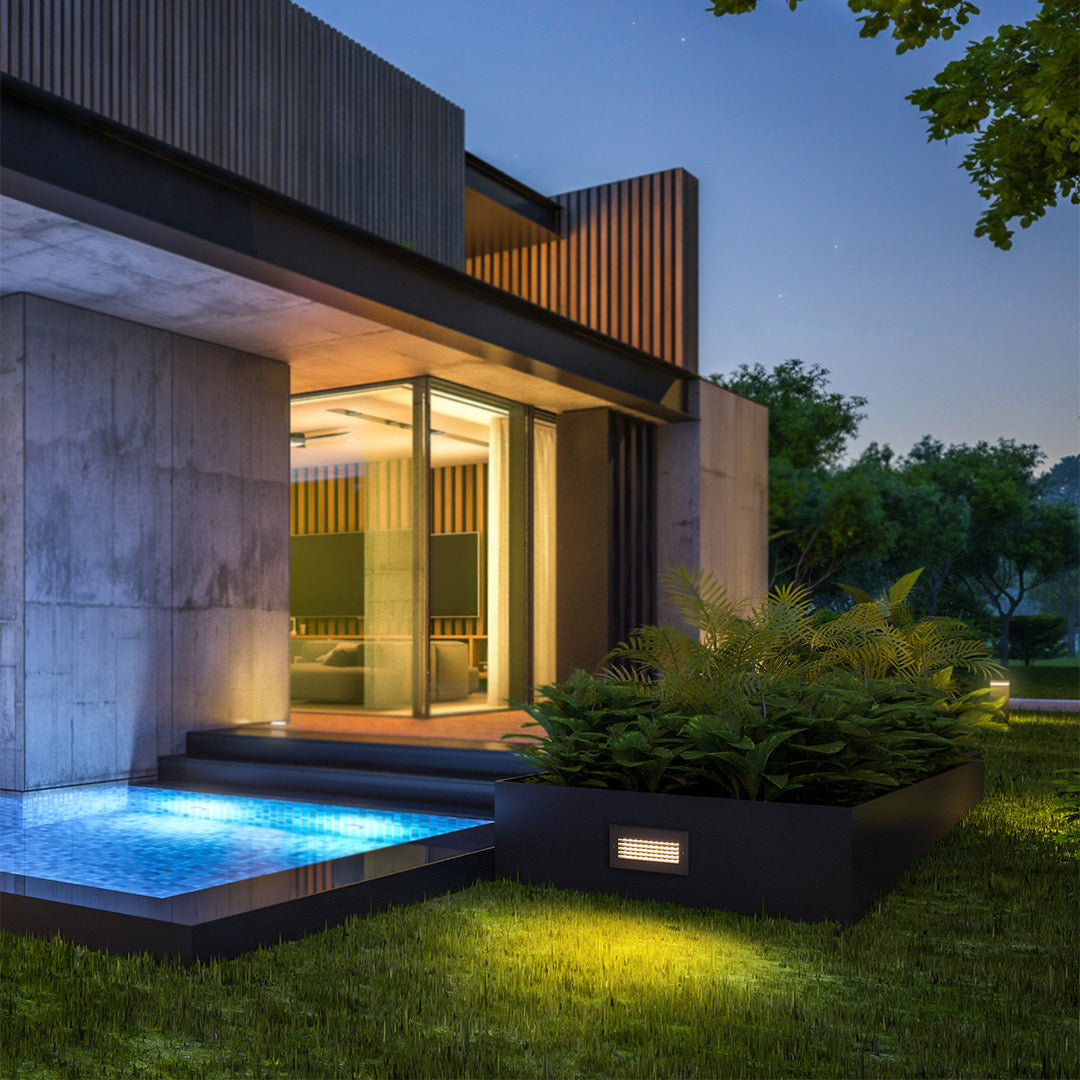 Contemporary residential exterior featuring modern lighting design with pool area and landscape illumination