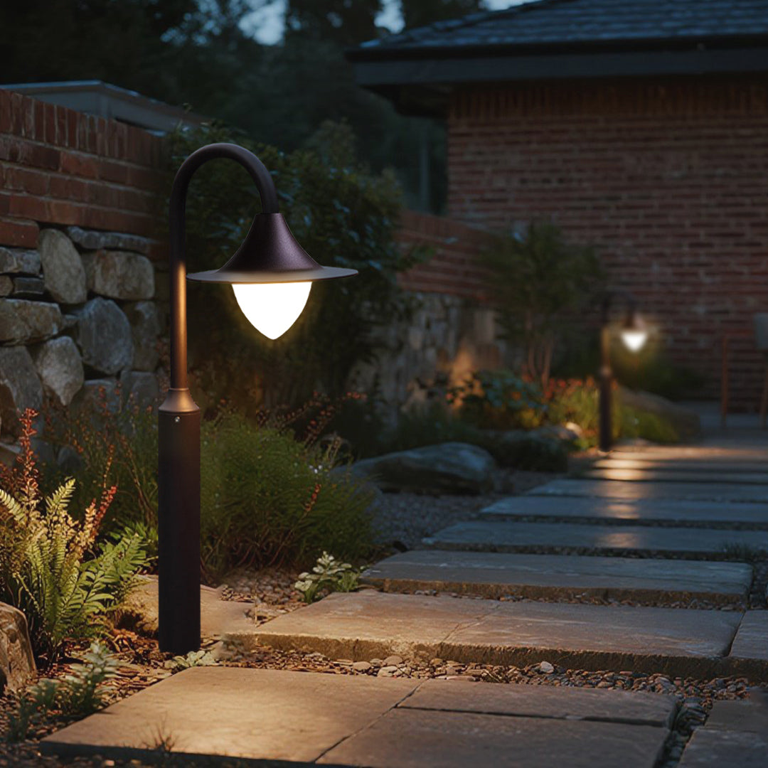 Contemporary landscape scene featuring shepherd's hook bollards integrated with stone and water elements