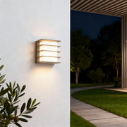 Contemporary square LED wall lights featuring glass shade chandelier styling creating warm ambient glow on interior and exterior walls.