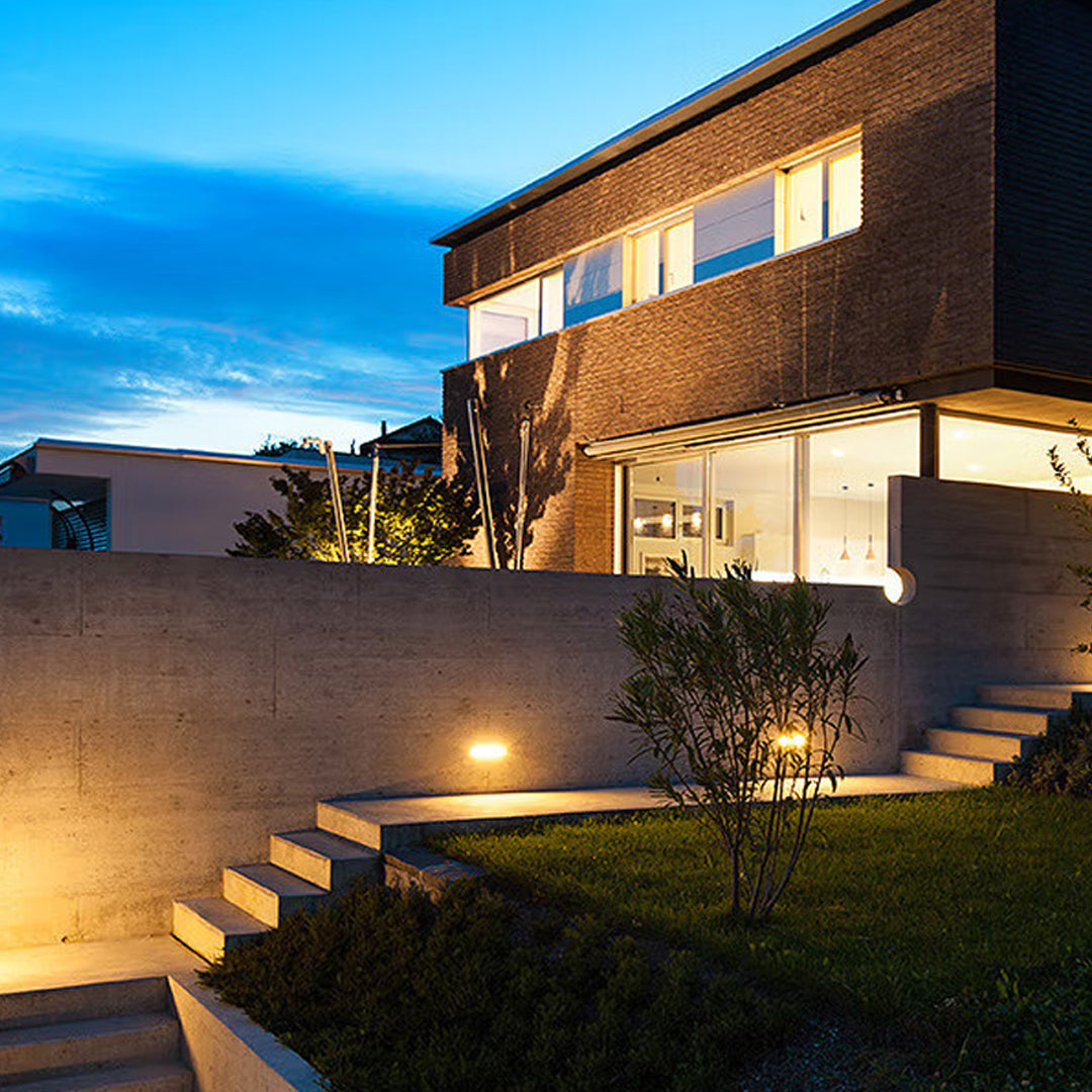 Circular recessed wall light installed in stone surface creating subtle accent lighting