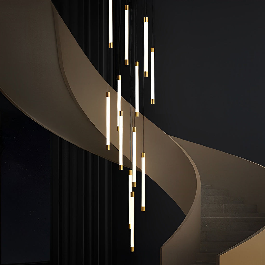 Contemporary staircase chandelier with vertical lights, adding drama to a dark, modern staircase.