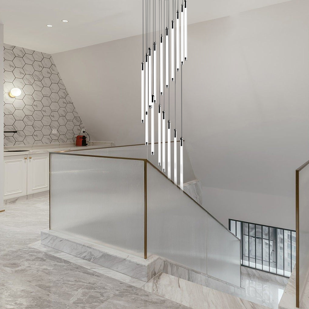 Contemporary staircase chandelier with vertical lights, adding elegance to a white staircase.