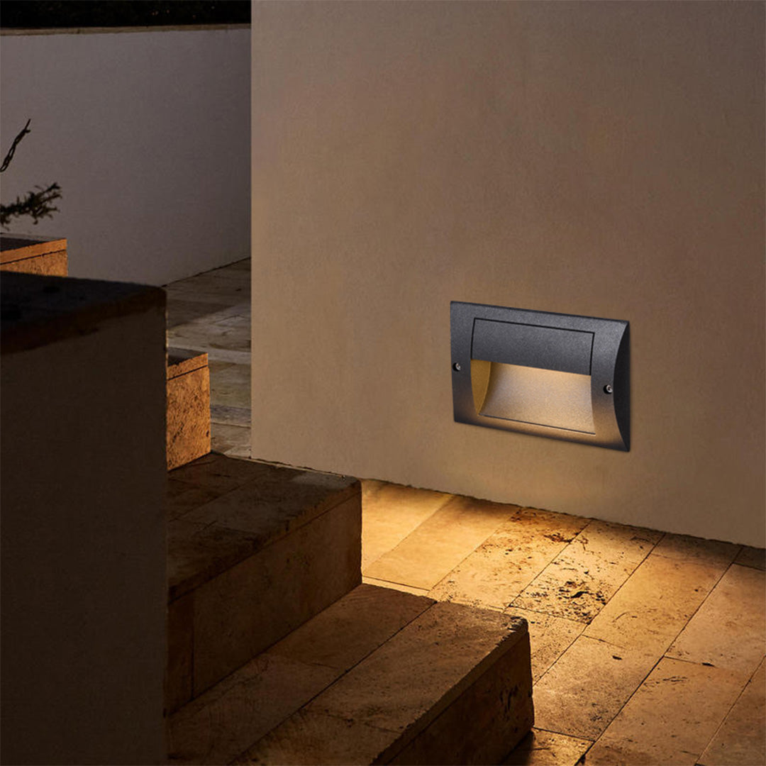 Compact black square step light fixture designed for flush mounting in outdoor wall applications