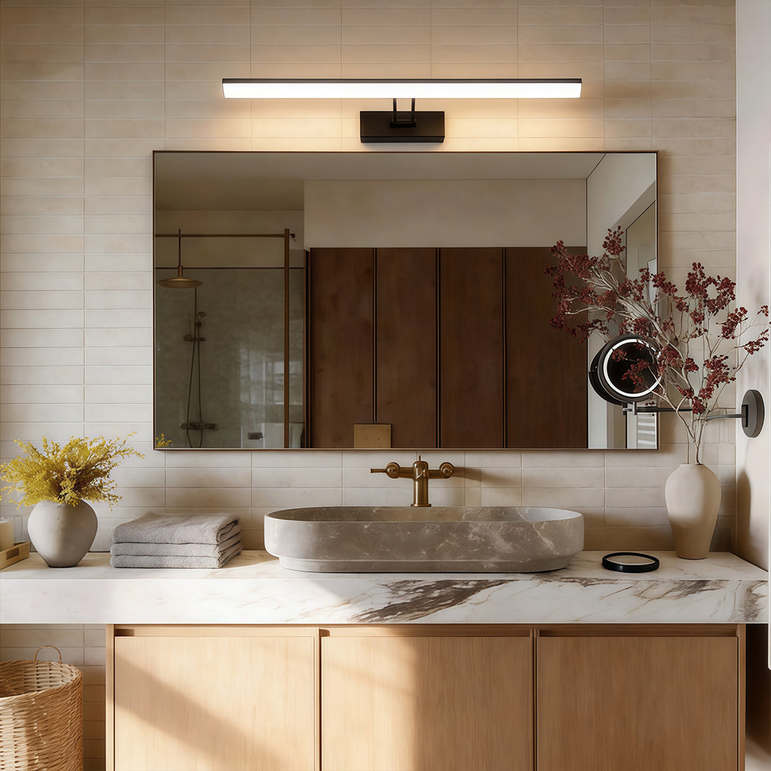 Contemporary vanity light bar with a minimalist design, enhancing a stylish bathroom with marble countertop.