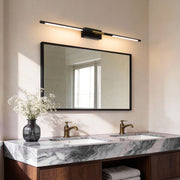 Contemporary vanity light bar illuminating a modern marble bathroom with warm, elegant glow.