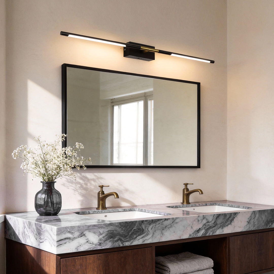 Contemporary vanity light bar illuminating a modern marble bathroom with warm, elegant glow.