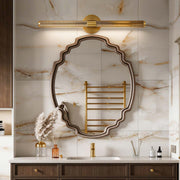 Contemporary vanity light bar with a sleek gold design, illuminating a luxurious bathroom mirror.