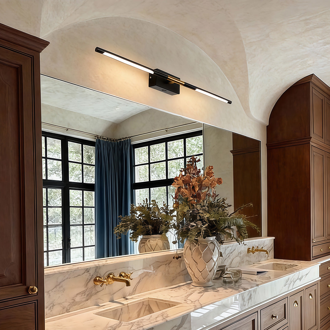 Contemporary vanity light bar providing soft illumination above a classic bathroom mirror.