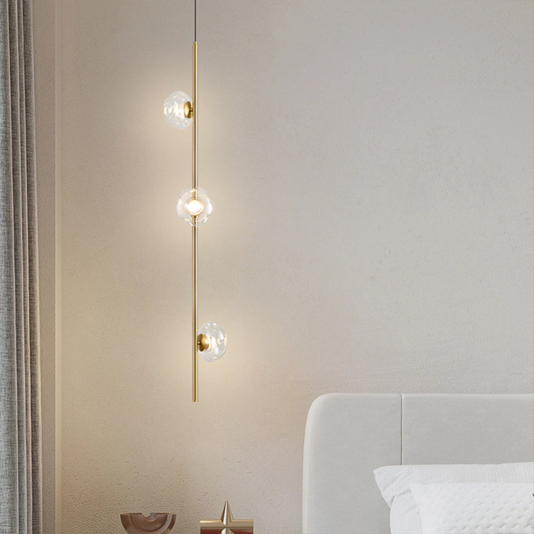 Contemporary modern vertical pendant light installation in modern hallway with linear glass design