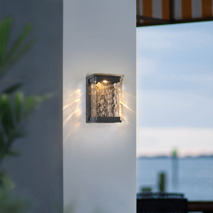 Contemporary wall light with textured glass panel mounted on blue residential building facade