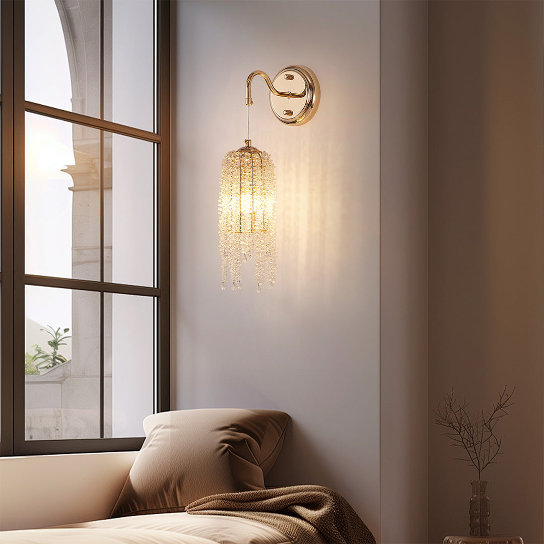 Contemporary wall lights with crystals and glass shade chandelier aesthetic providing warm illumination in modern neutral-toned bedroom.