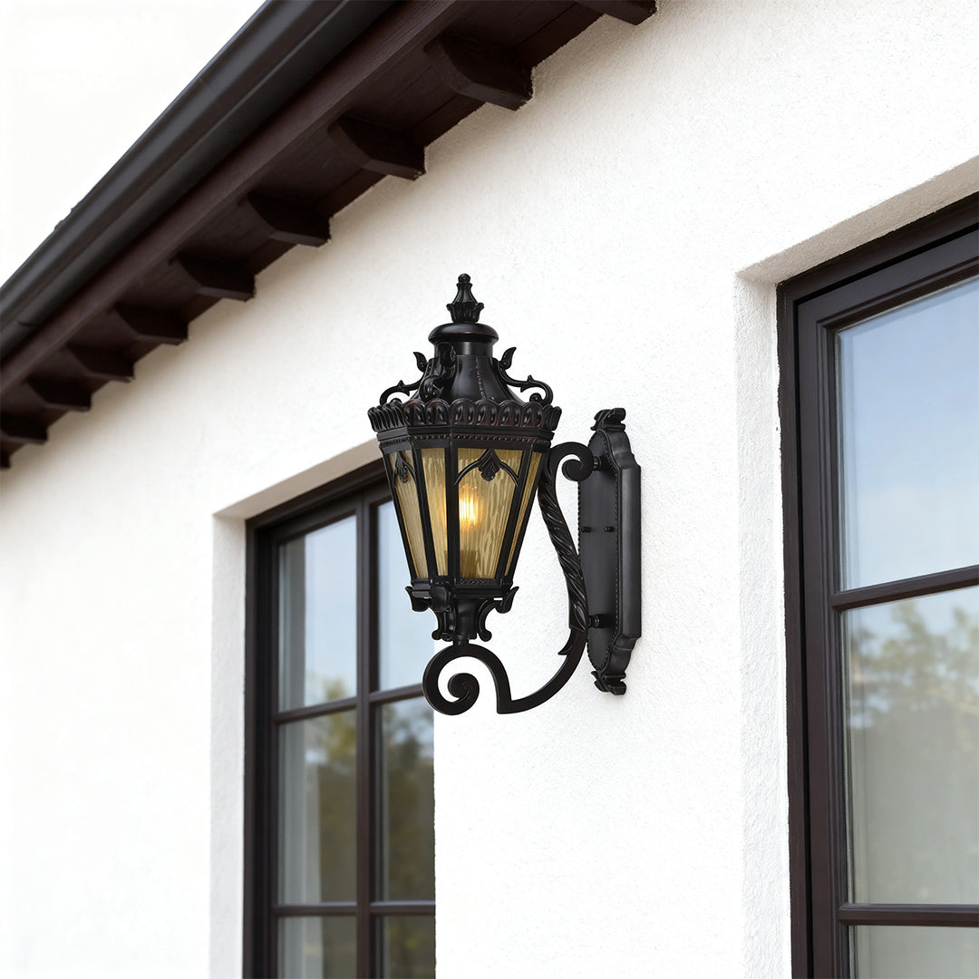 Contemporary wall mount light outdoor mounted on white stucco beside modern black window frame